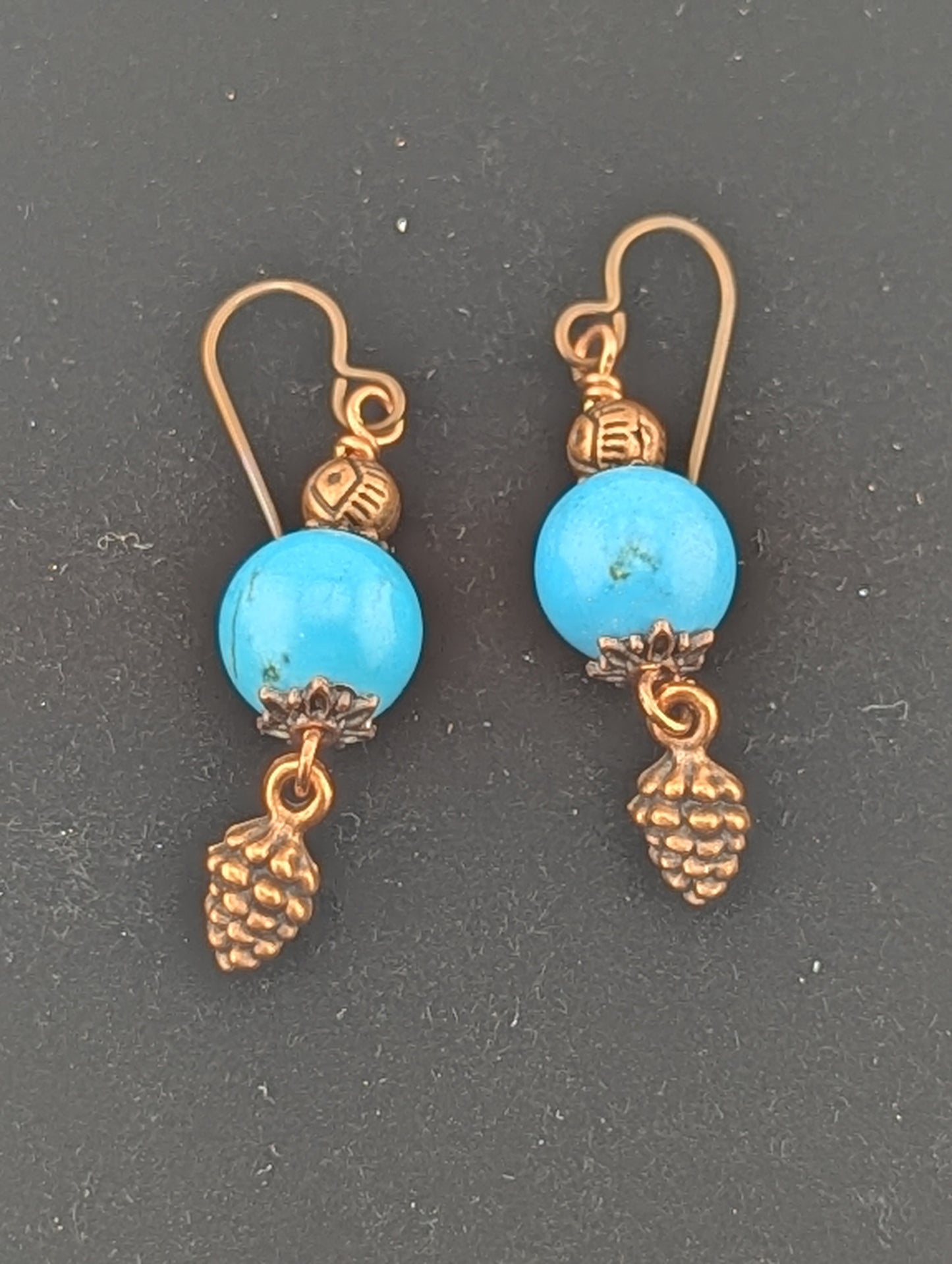 Turquoise earrings with a Pine Cone charm in antiqued Copper finish