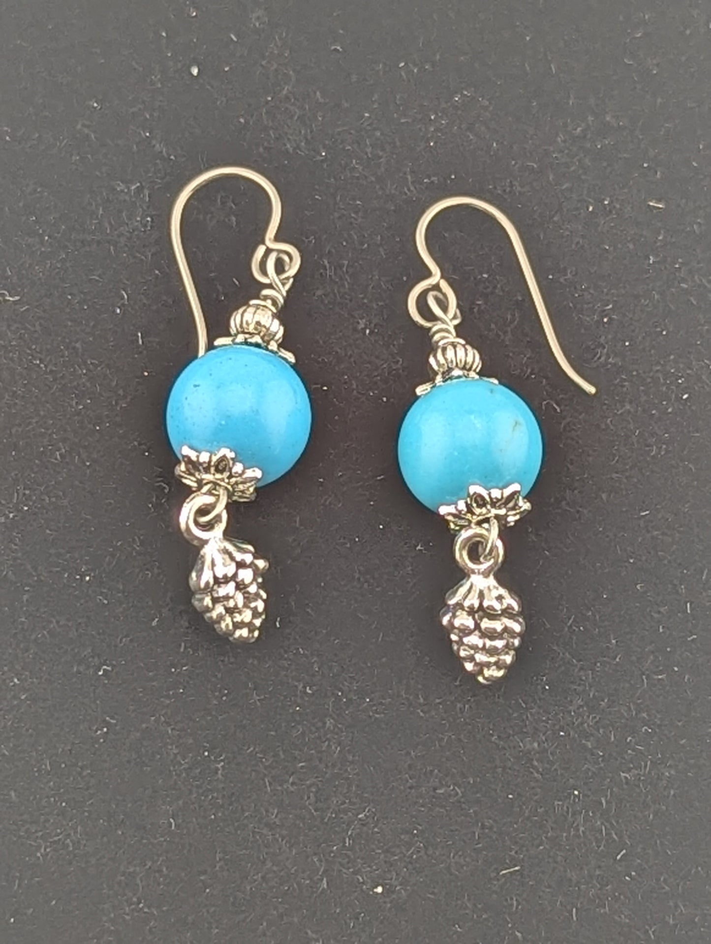 Turquoise earrings with a Pine Cone charm in antiqued Silver finish