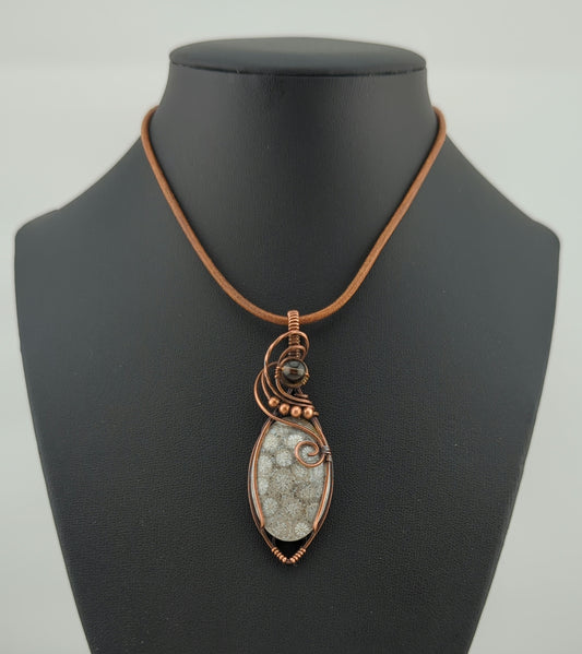 Coral Fossil Pendant, set in antiqued copper, accented with Smokey Quartz.