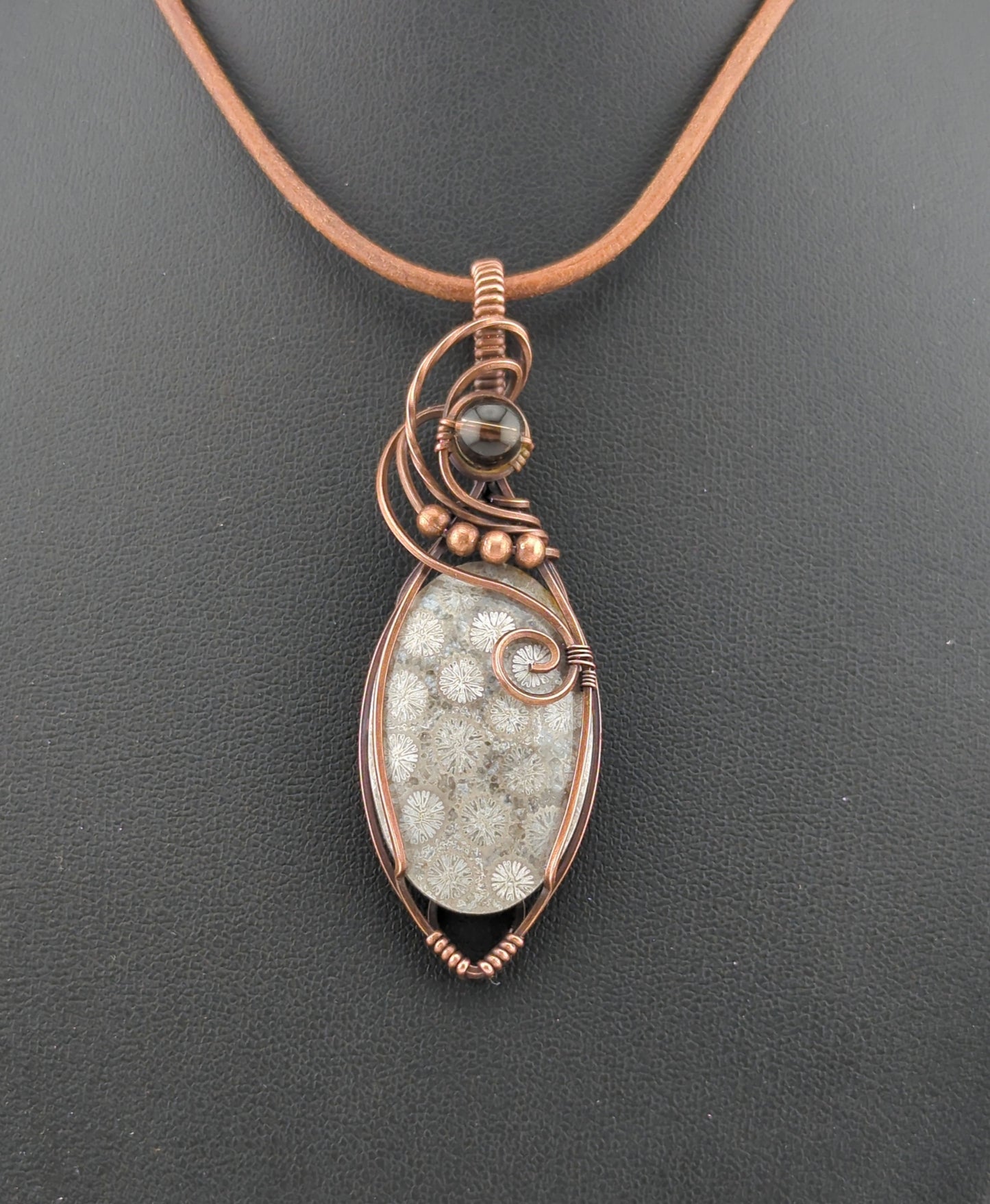 Coral Fossil Pendant, set in antiqued copper, accented with Smokey Quartz.