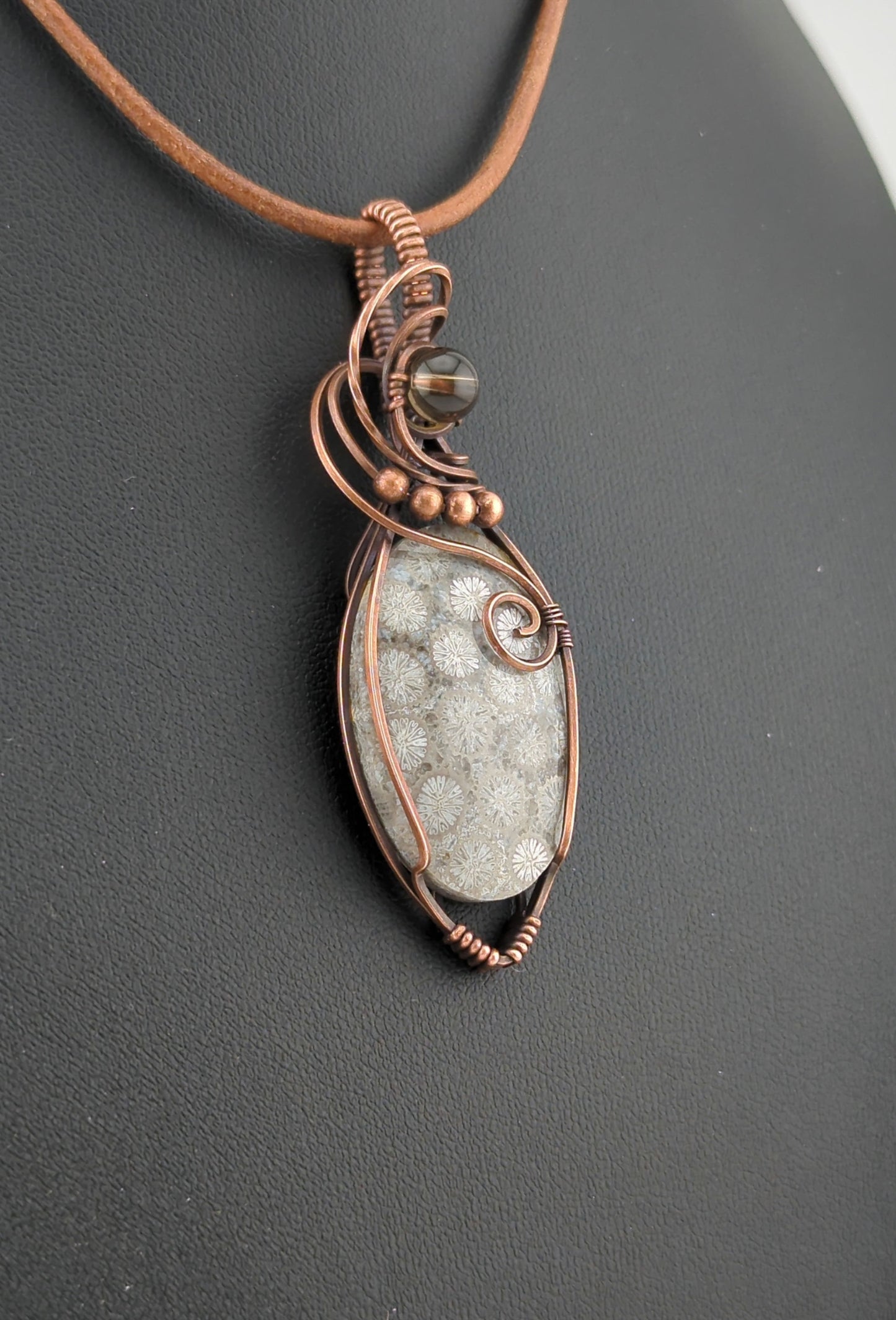 Coral Fossil Pendant, set in antiqued copper, accented with Smokey Quartz.