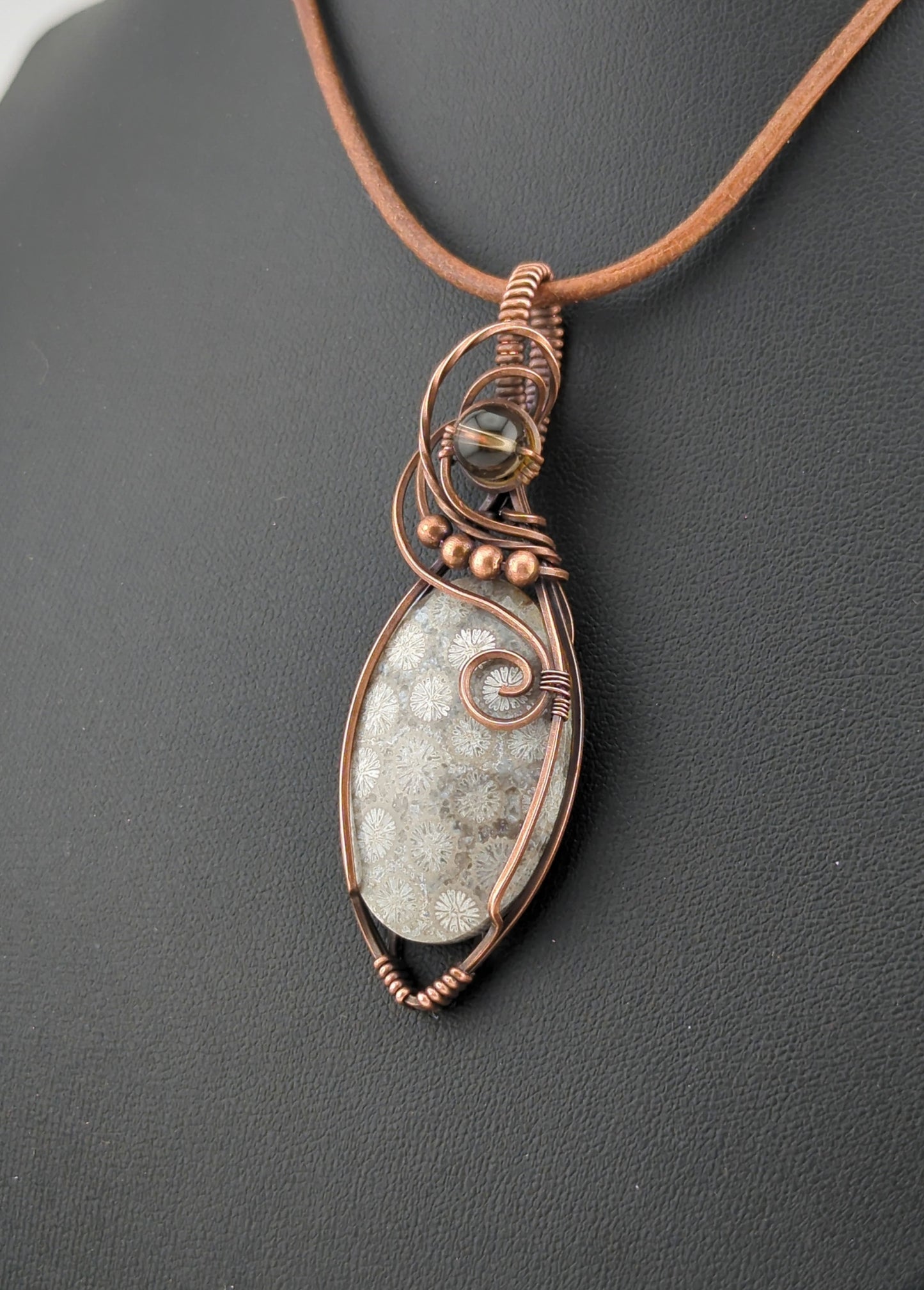 Coral Fossil Pendant, set in antiqued copper, accented with Smokey Quartz.