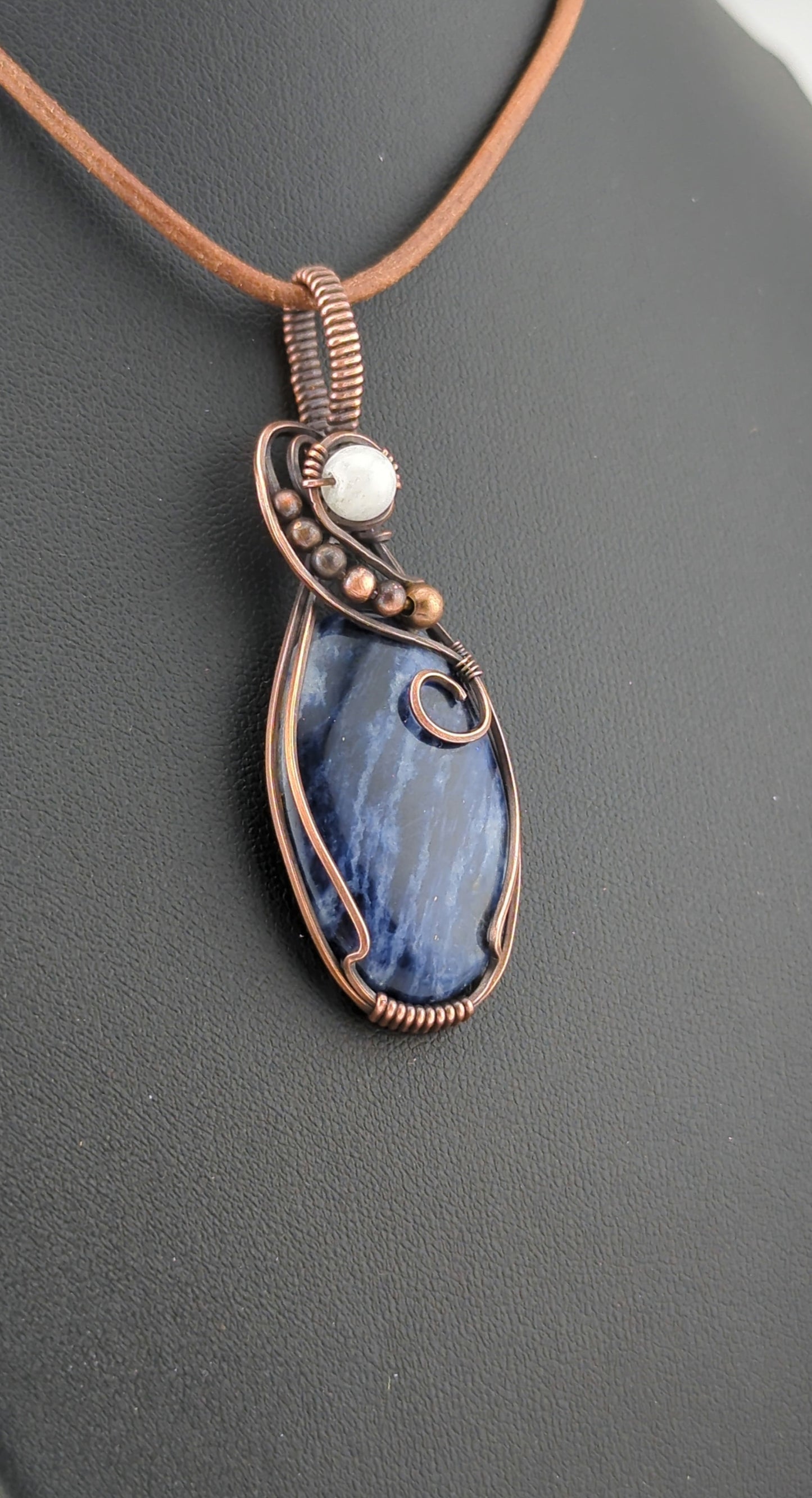 Sodalite Pendant, set in antiqued copper, accented with Moonstone.