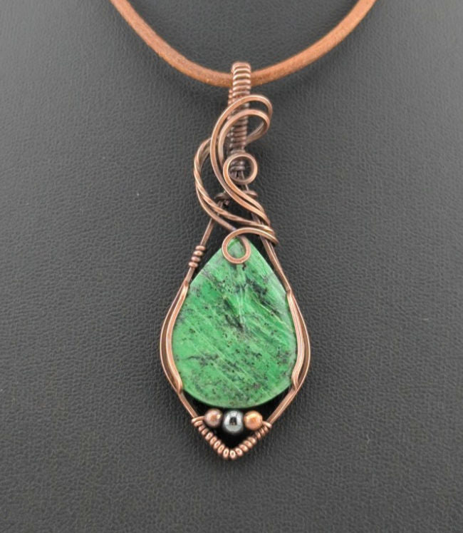 Maw Sit Sit Pendant, set in antiqued copper, accented with Hematite.