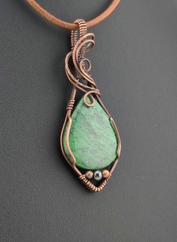 Maw Sit Sit Pendant, set in antiqued copper, accented with Hematite.