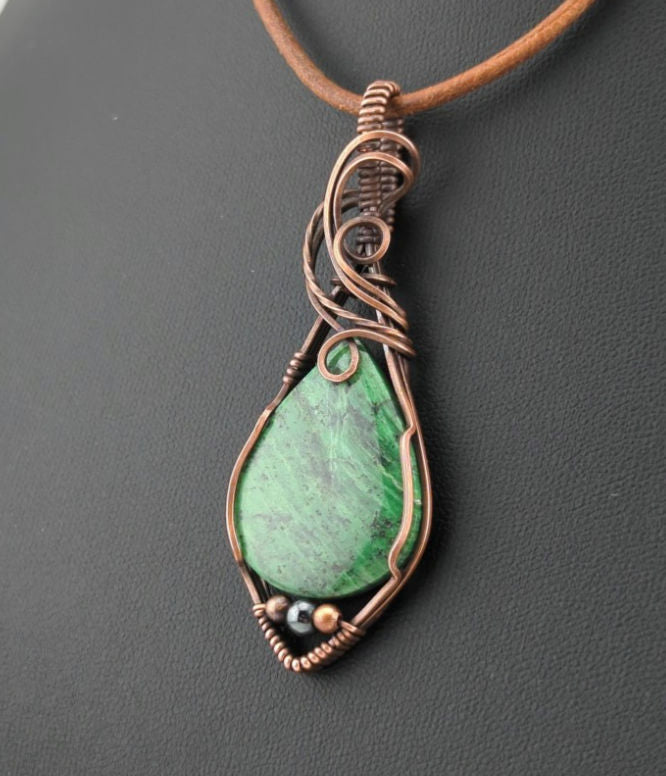 Maw Sit Sit Pendant, set in antiqued copper, accented with Hematite.