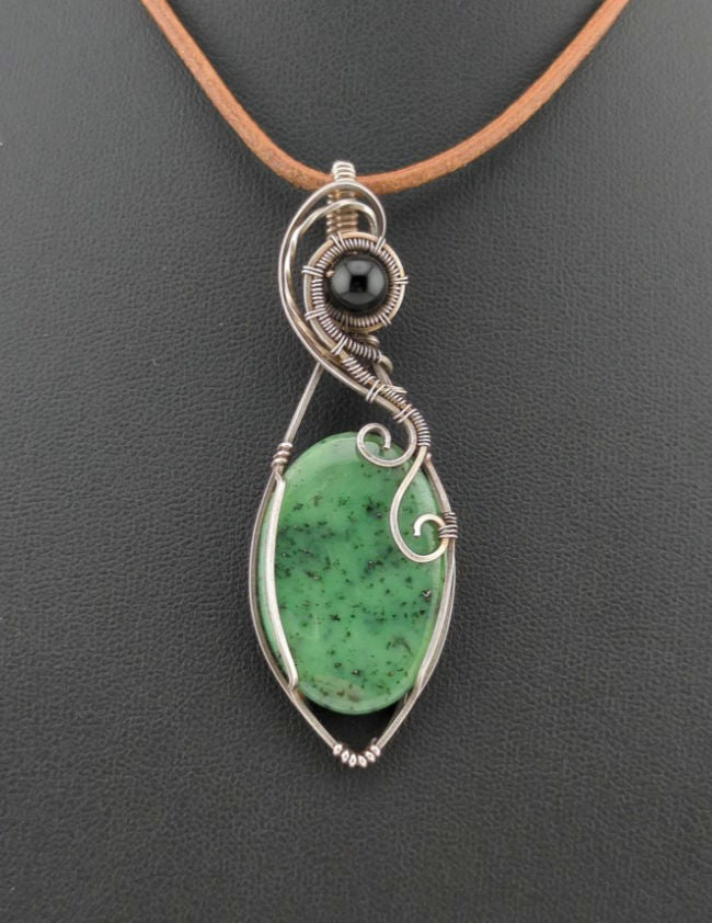 Maw Sit Sit Pendant, set in Sterling Silver, accented with black Agate.