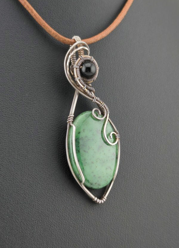 Maw Sit Sit Pendant, set in Sterling Silver, accented with black Agate.