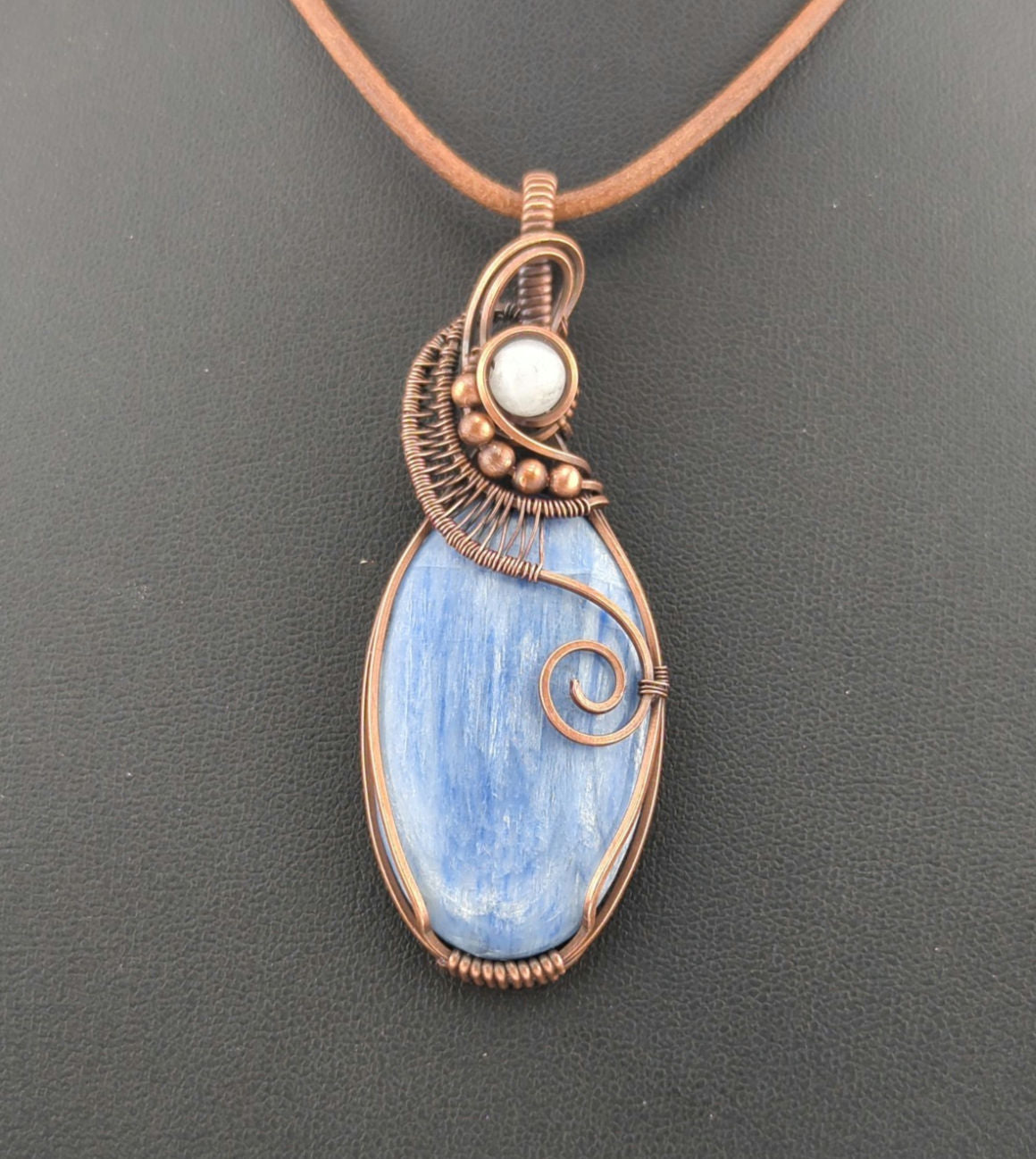 Kyanite, set in antiqued copper, accented with Moonstone.