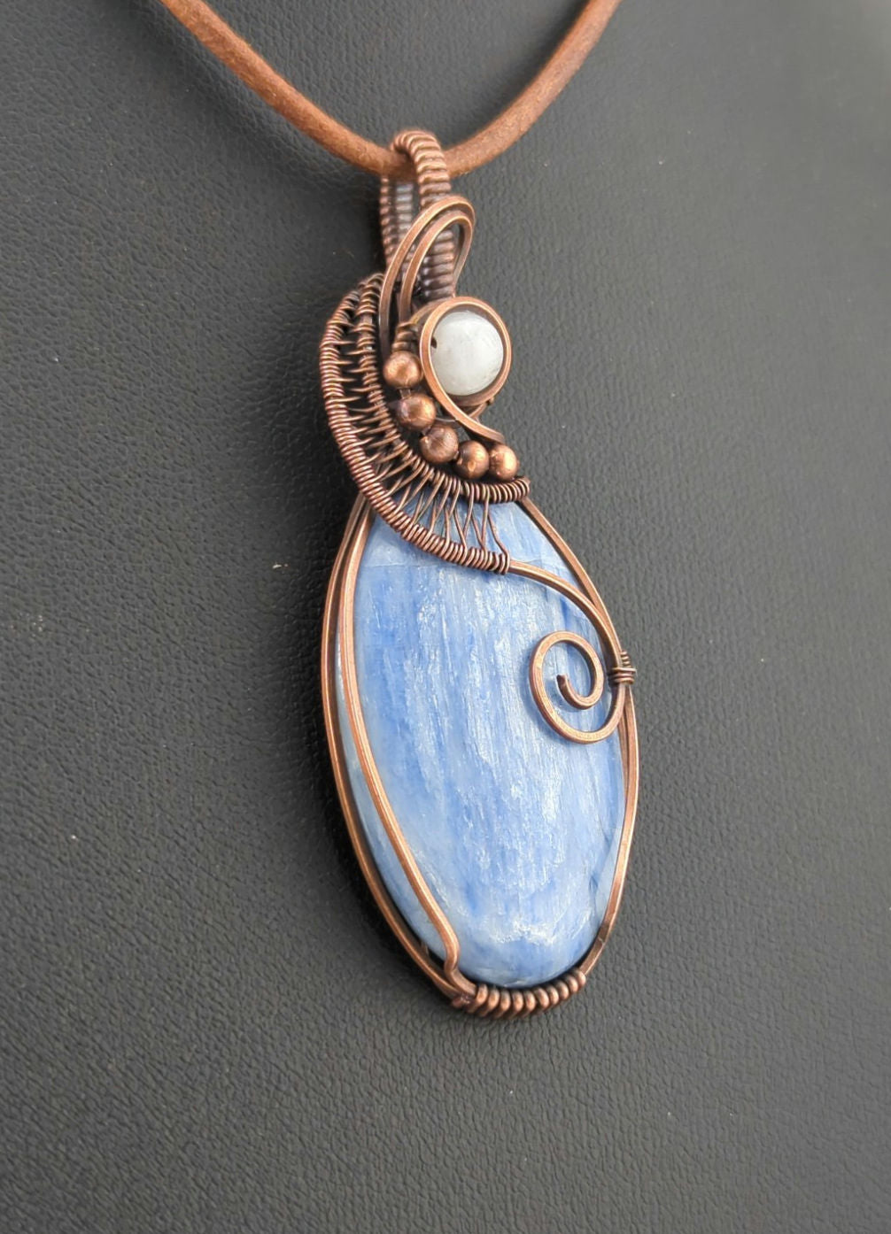 Kyanite, set in antiqued copper, accented with Moonstone.