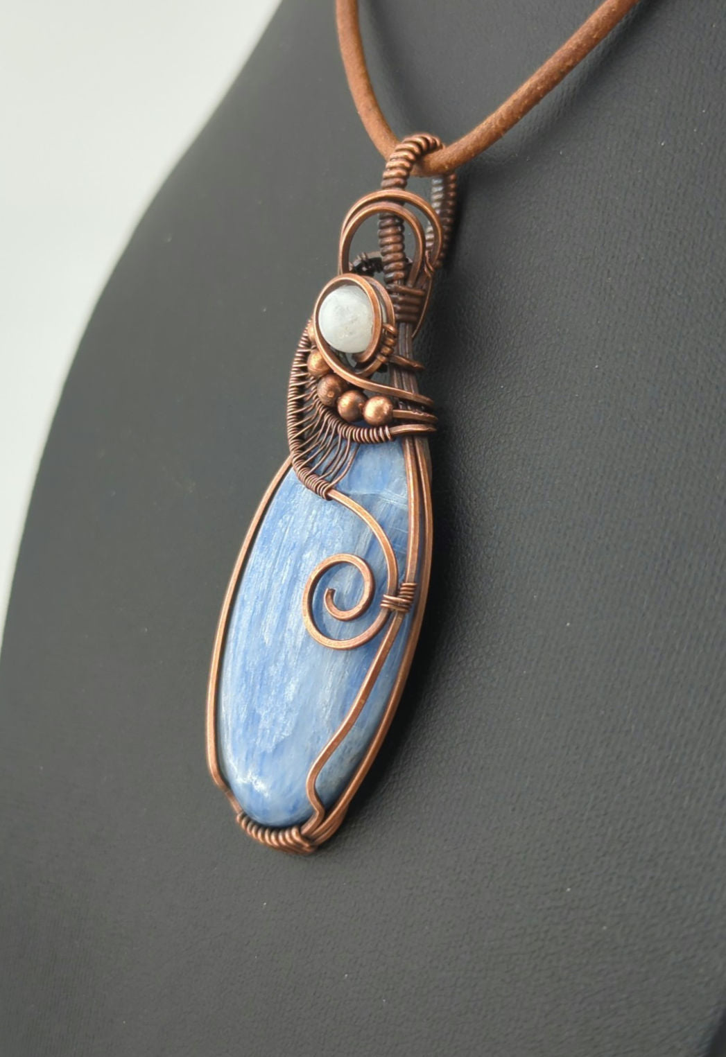 Kyanite, set in antiqued copper, accented with Moonstone.