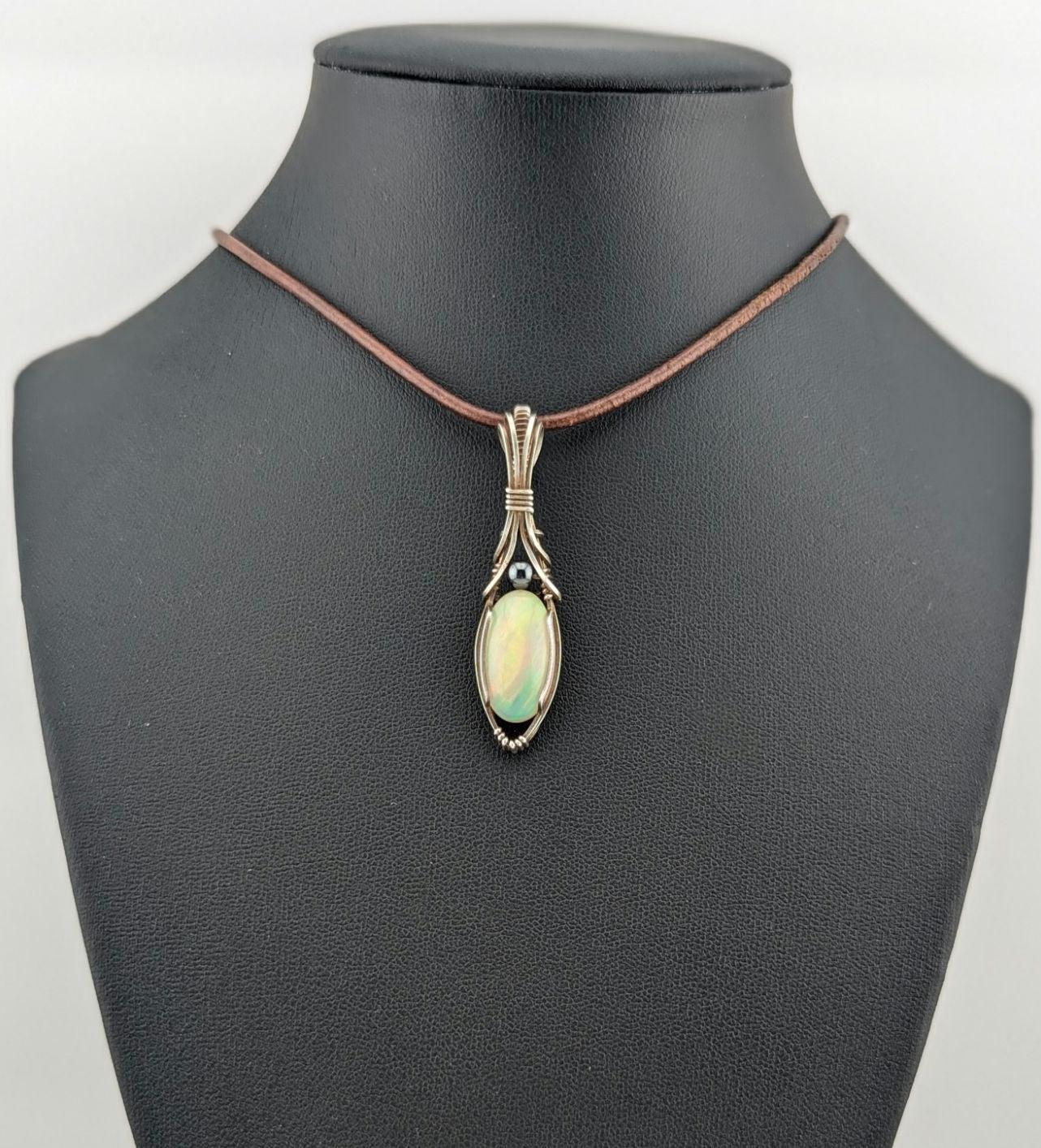 Ethiopian Opal Gemstone Pendant, accented with Hematite and set in Sterling Silver