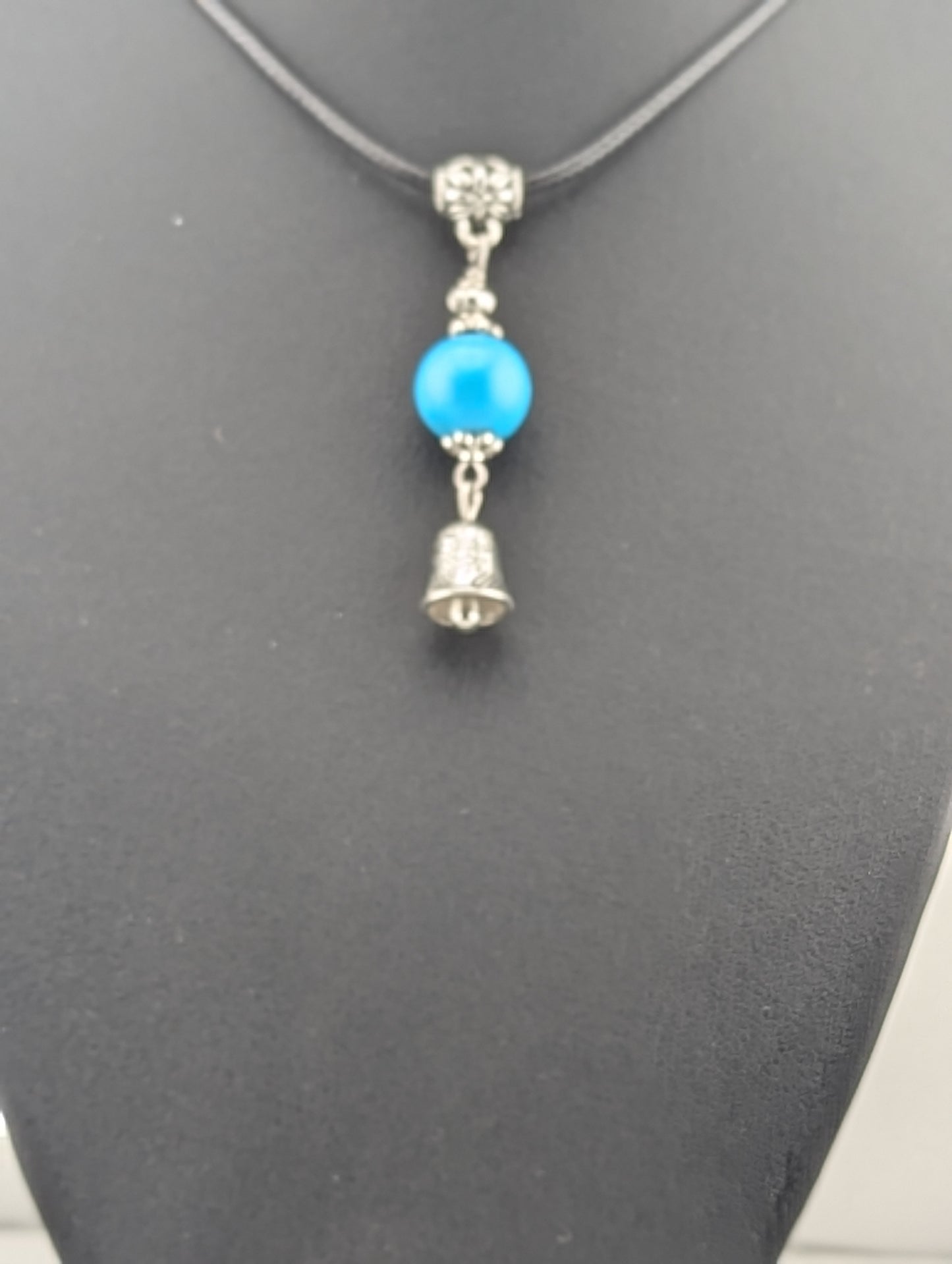 Turquoise pendant with a Bell charm, in antiqued Silver finish