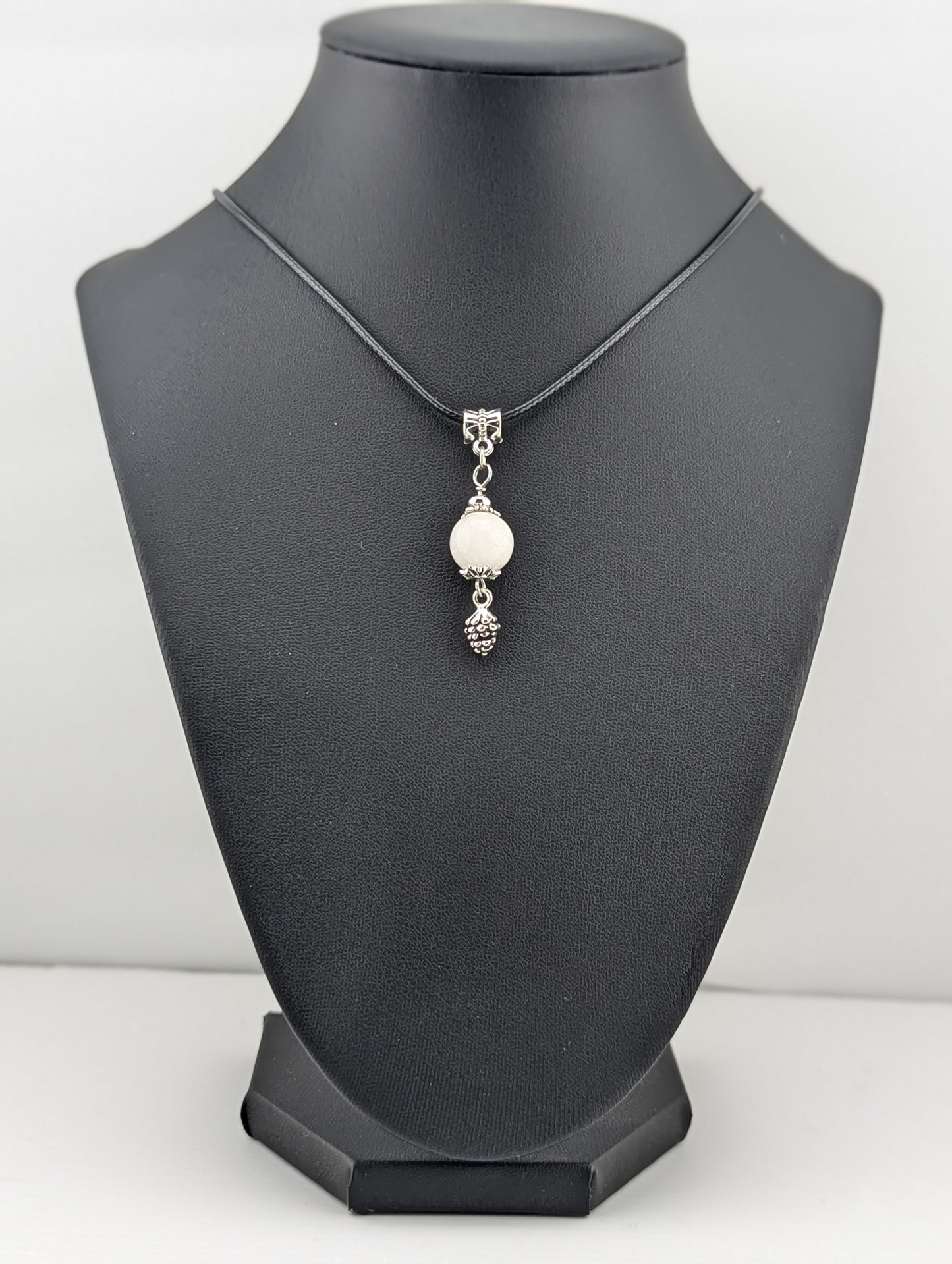 Moonstone pendant with a pine cone charm in antiqued Silver finish