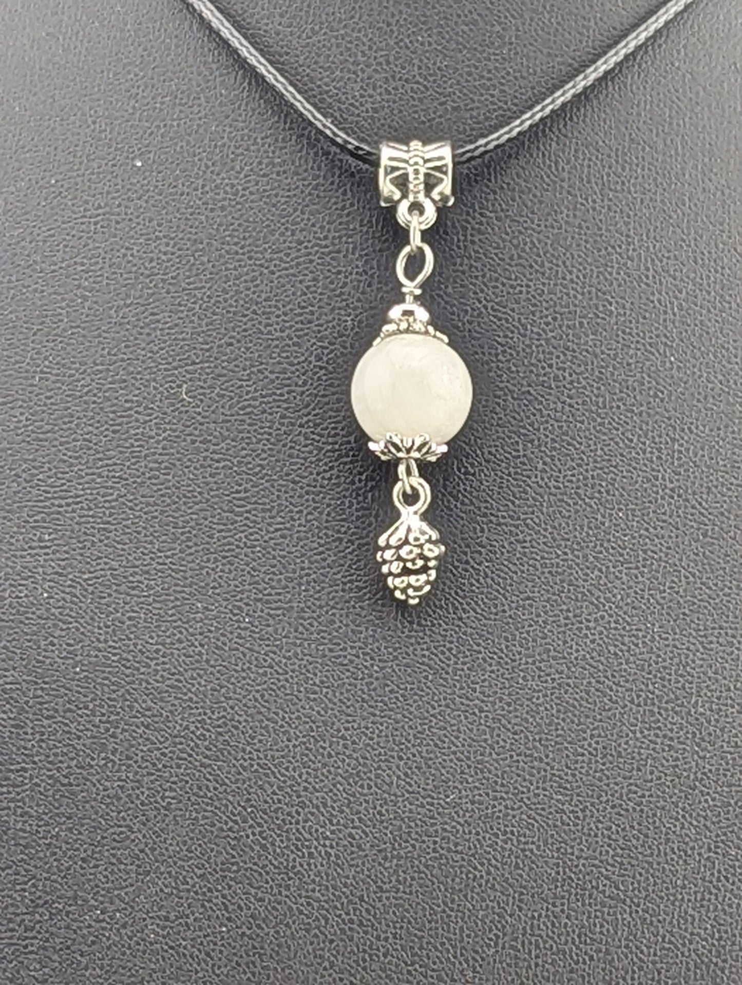 Moonstone pendant with a pine cone charm in antiqued Silver finish