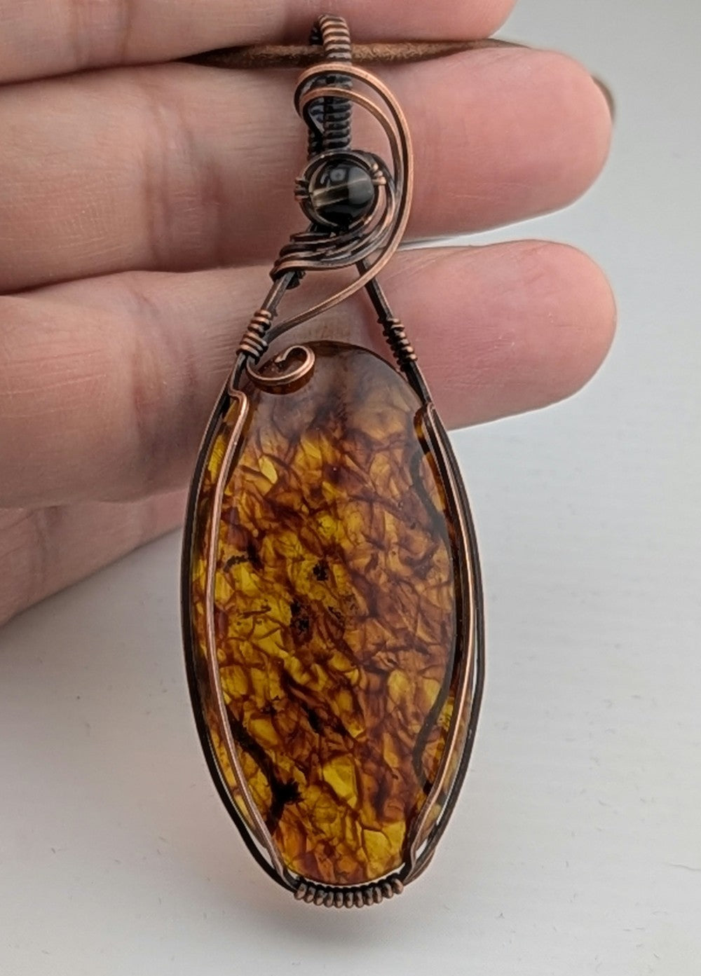 Amber Pendant, accented with Smokey Quartz and set in antiqued copper.