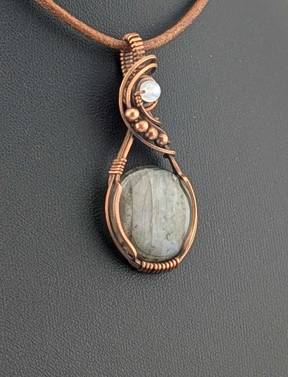 Labradorite gemstone pendant with Blue and Silver flash, accented with Moonstone and set in antiqued copper.