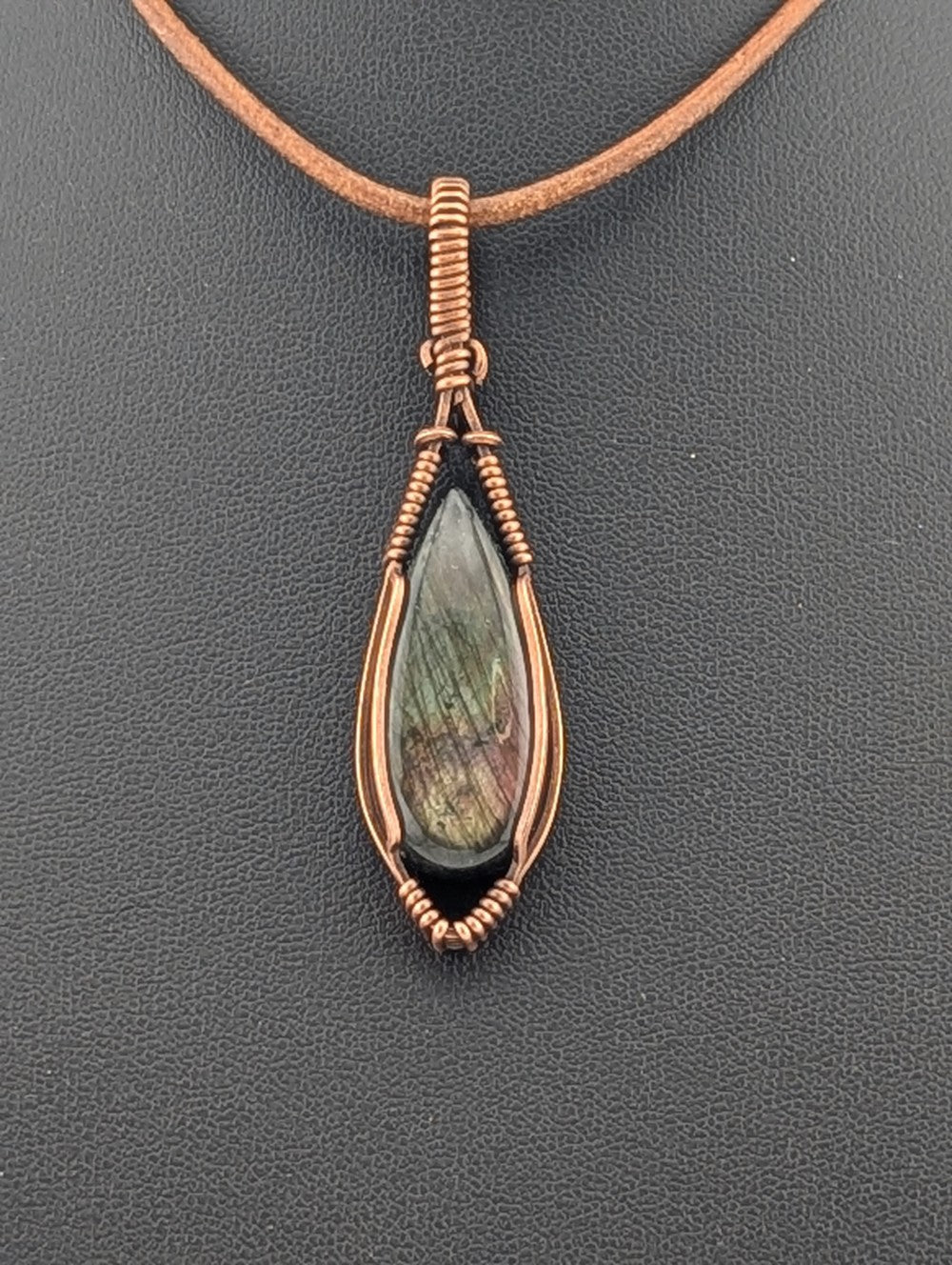 Labradorite pendant with purple and green flash, set in antiqued copper.