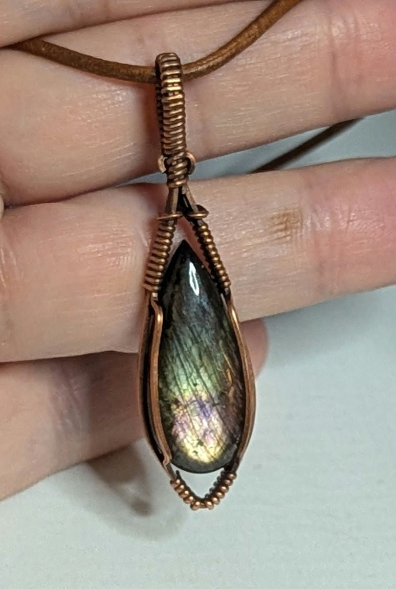 Labradorite pendant with purple and green flash, set in antiqued copper.