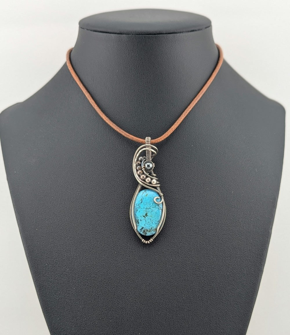 Kingman Turquoise pendant, accented with hematite and set in antiqued Silver.