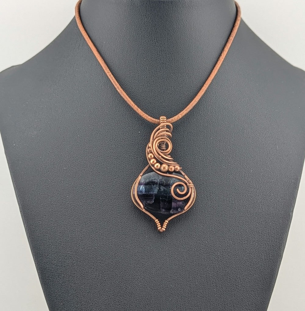 Fluorite gemstone pendant, rainbow blue and purple set in antiqued copper.