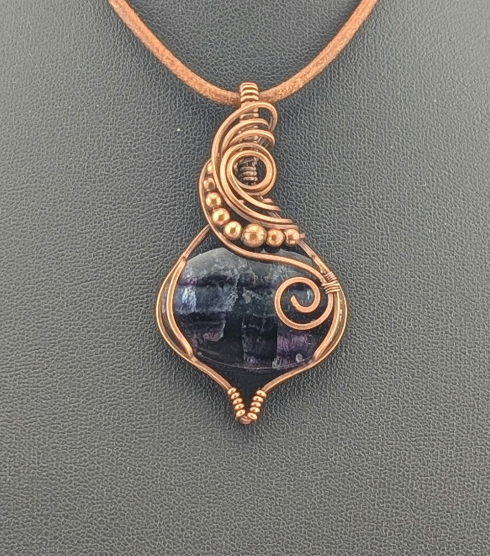 Fluorite gemstone pendant, rainbow blue and purple set in antiqued copper.