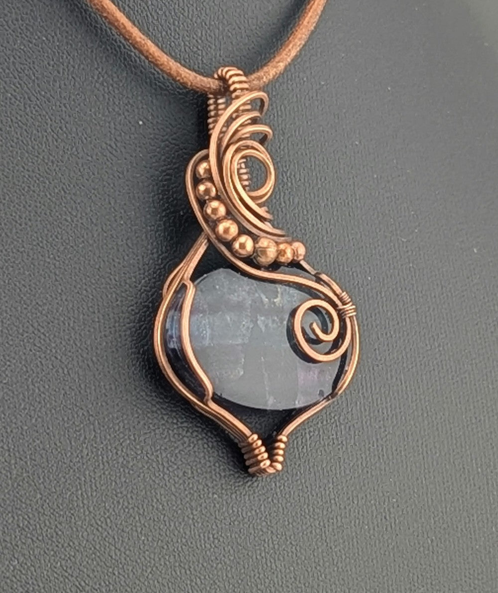 Fluorite gemstone pendant, rainbow blue and purple set in antiqued copper.