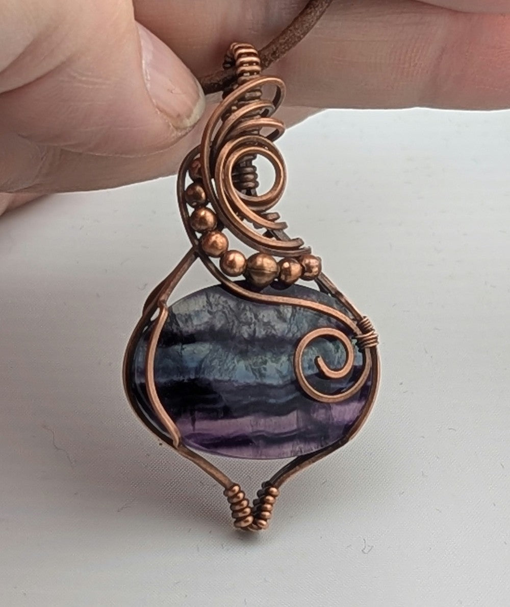 Fluorite gemstone pendant, rainbow blue and purple set in antiqued copper.