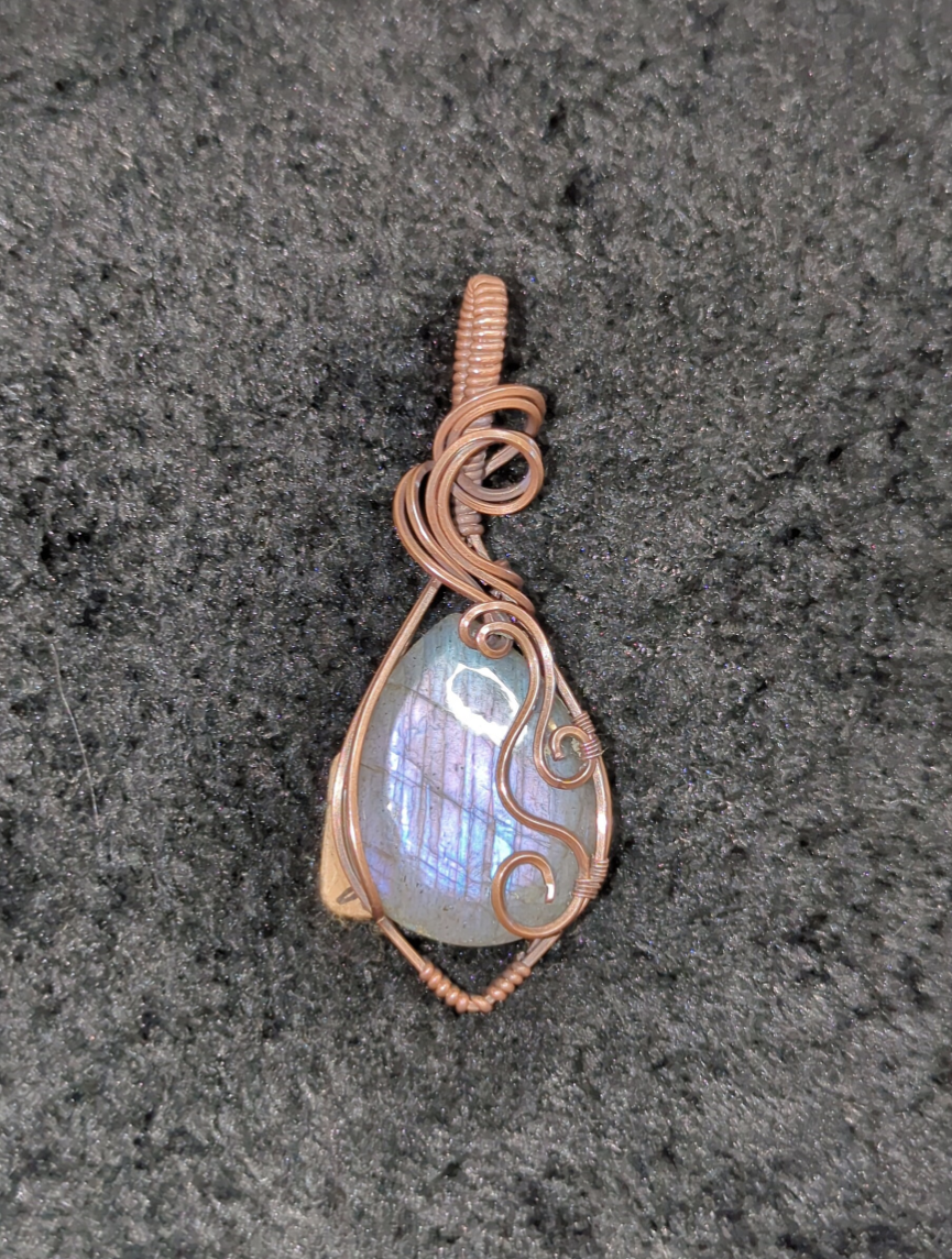 Labradorite pendant with blue and purple flash, set in antiqued copper.