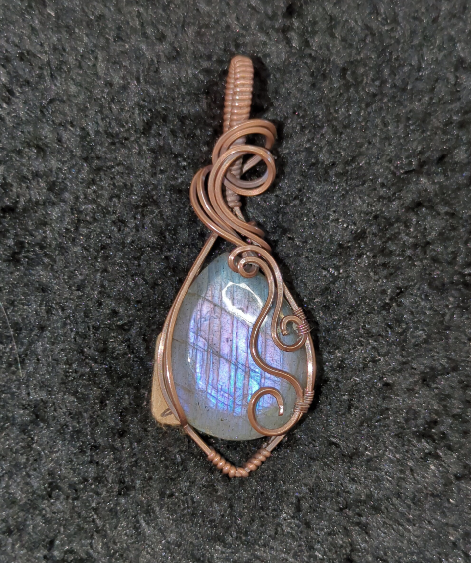 Labradorite pendant with blue and purple flash, set in antiqued copper.