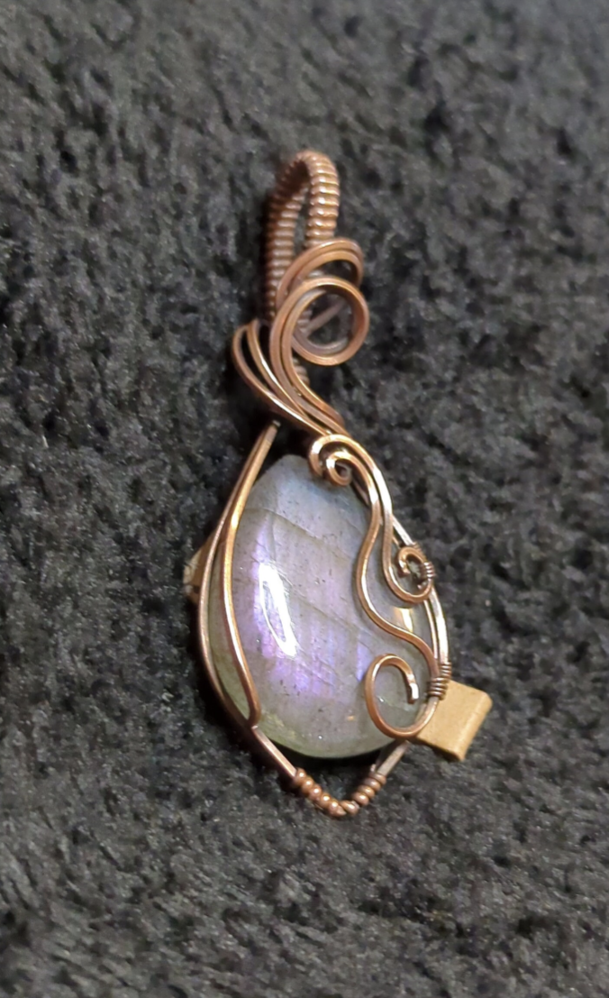 Labradorite pendant with blue and purple flash, set in antiqued copper.