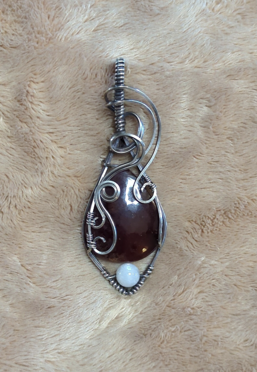 Garnet gemstone pendant, set in Sterling silver. with a moonstone bead for accent.