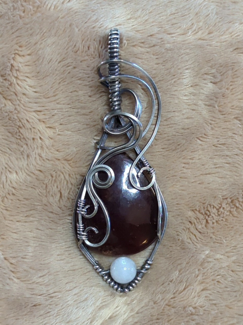 Garnet gemstone pendant, set in Sterling silver. with a moonstone bead for accent.