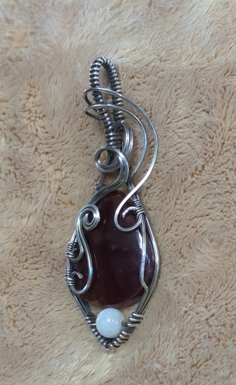 Garnet gemstone pendant, set in Sterling silver. with a moonstone bead for accent.