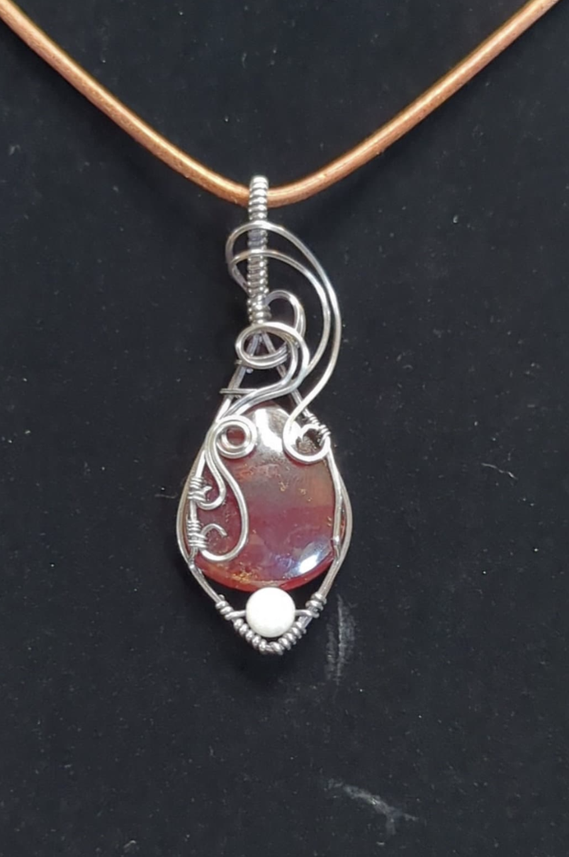 Garnet gemstone pendant, set in Sterling silver. with a moonstone bead for accent.