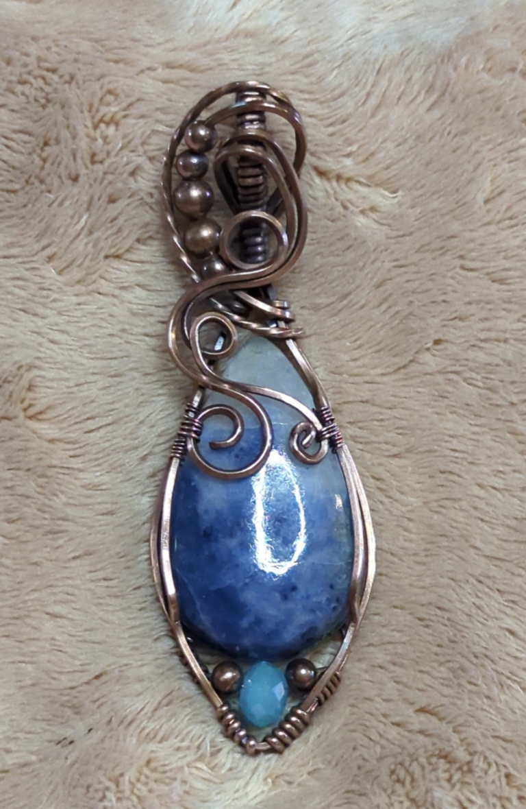 Sodalite Pendant, set in antiqued copper. Accented with a light blue Swarovski and copper beads.