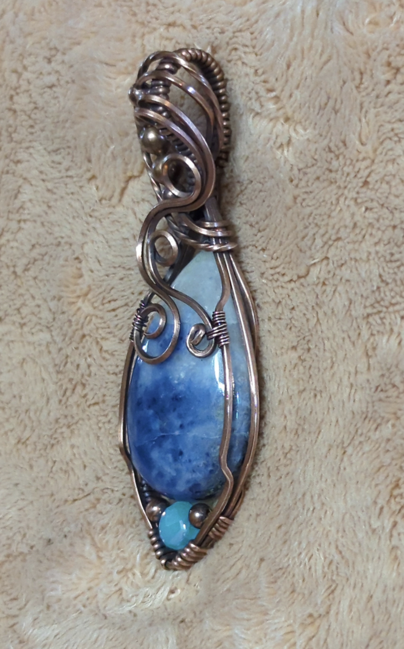 Sodalite Pendant, set in antiqued copper. Accented with a light blue Swarovski and copper beads.