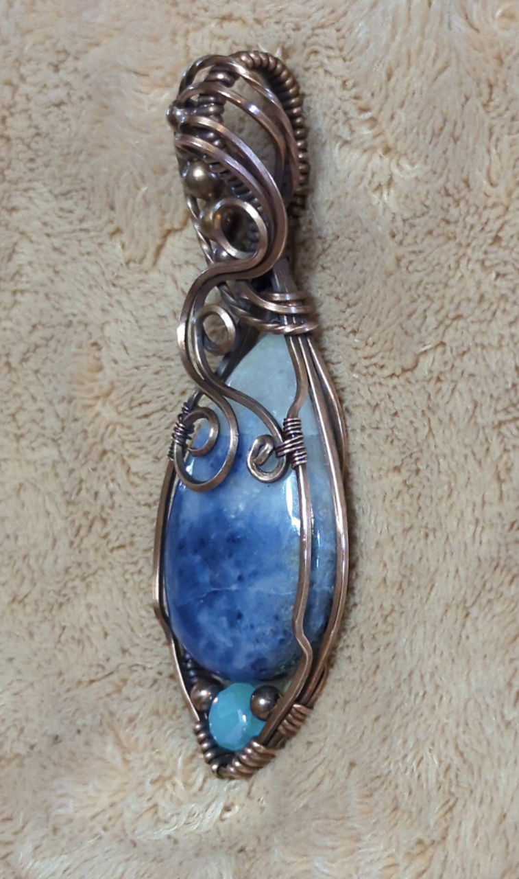 Sodalite Pendant, set in antiqued copper. Accented with a light blue Swarovski and copper beads.