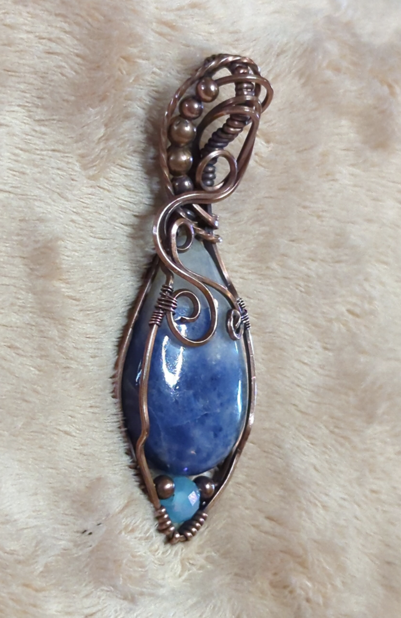 Sodalite Pendant, set in antiqued copper. Accented with a light blue Swarovski and copper beads.