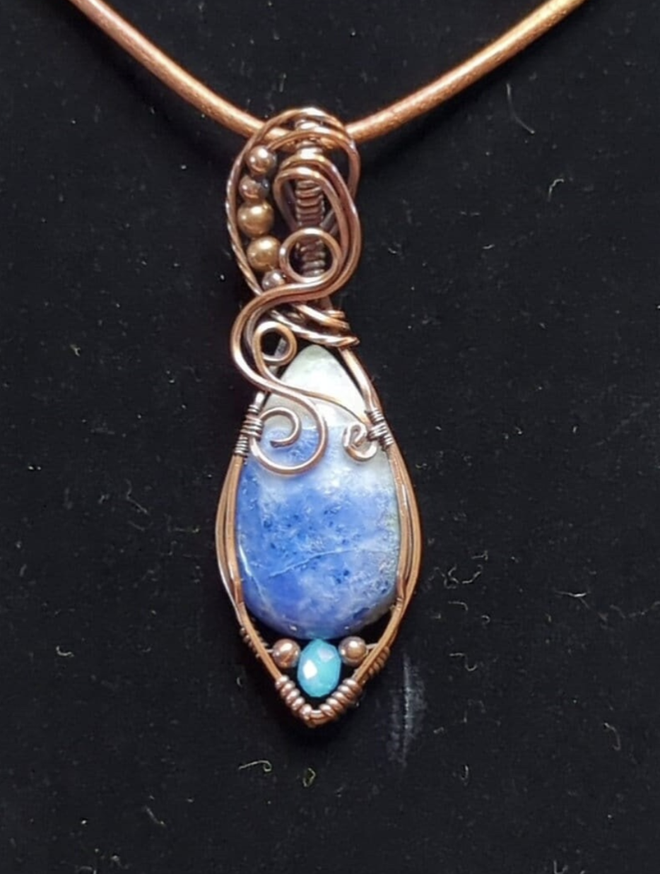 Sodalite Pendant, set in antiqued copper. Accented with a light blue Swarovski and copper beads.