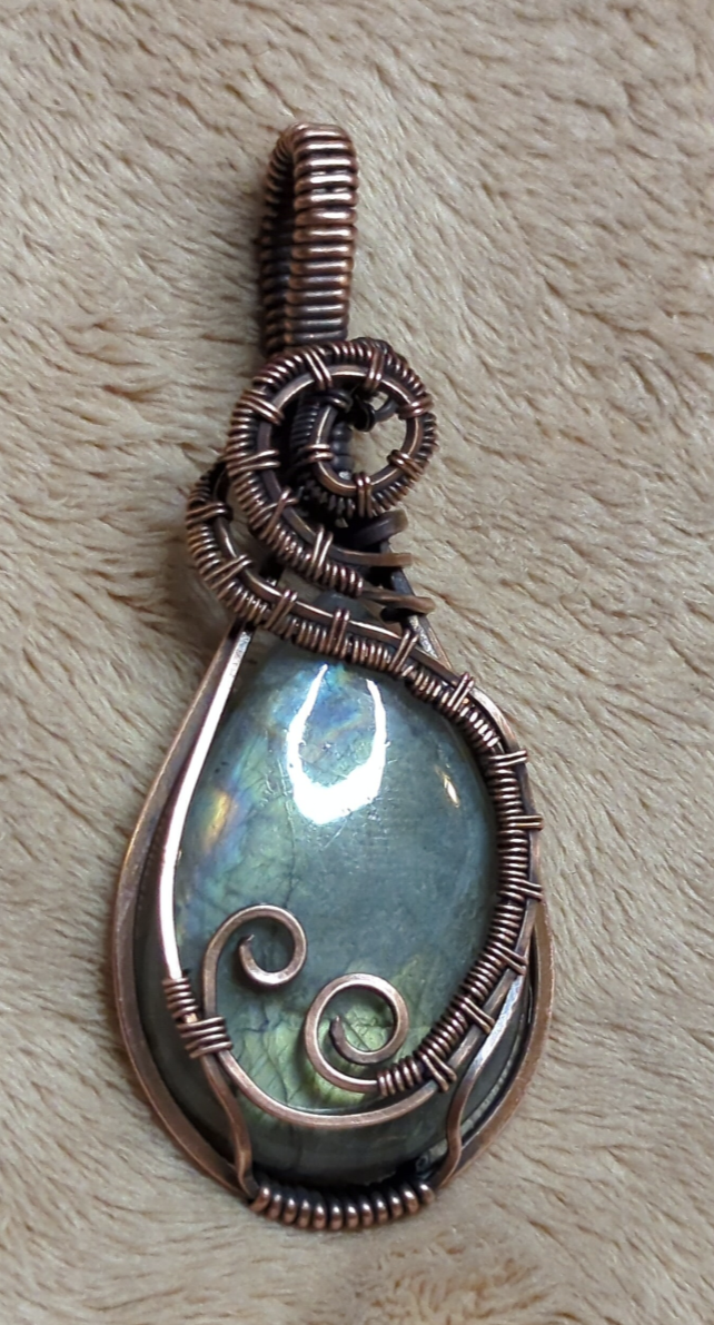 Labradorite gemstone pendant with blue and green flash, set in antiqued copper.