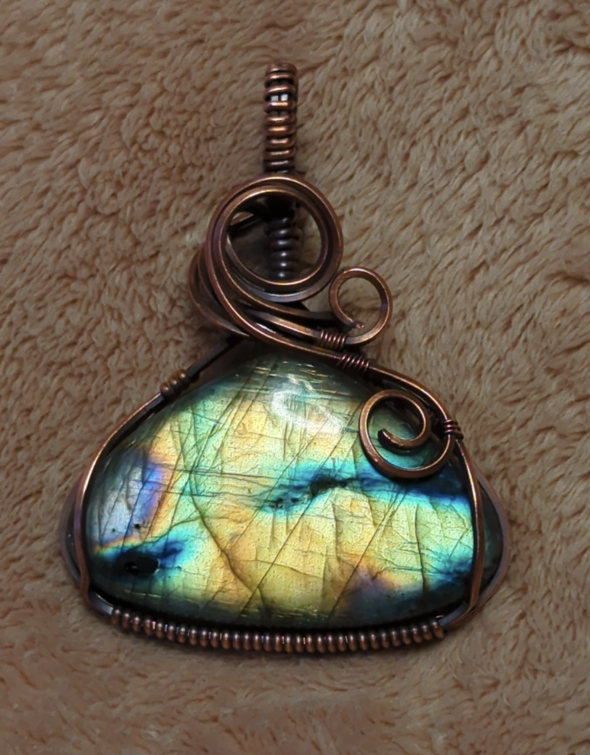 Labradorite gemstone pendant, with purple, green and blue flash, set in antiqued copper.