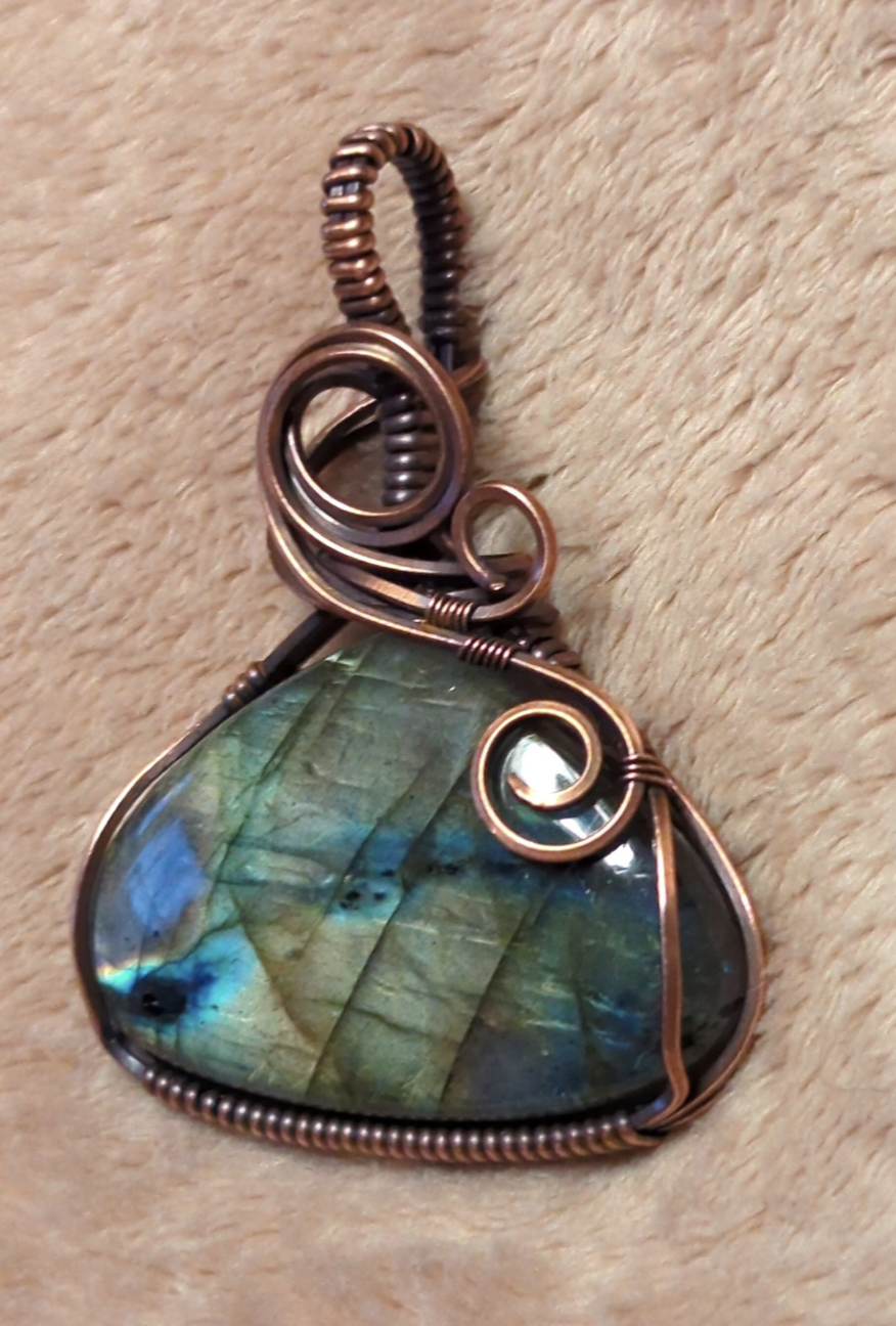 Labradorite gemstone pendant, with purple, green and blue flash, set in antiqued copper.