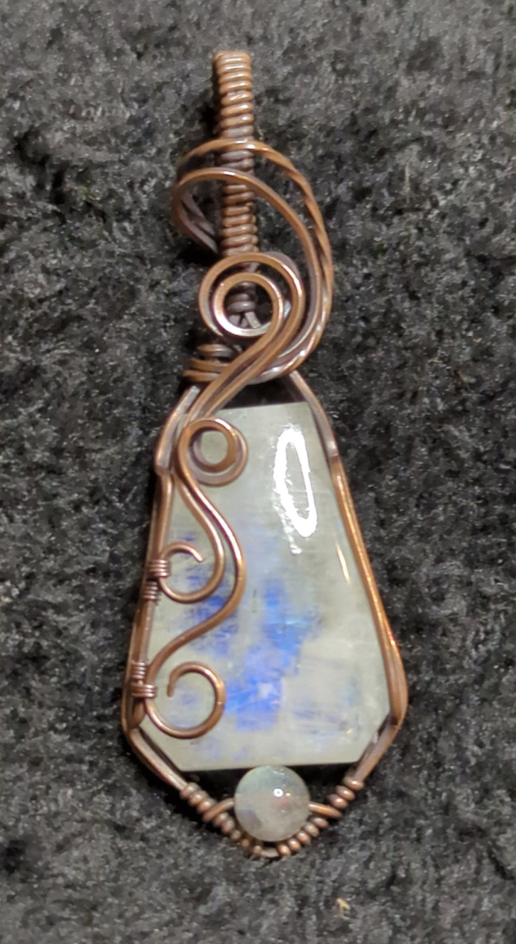 Moonstone pendant with blue flash, accented with Labradorite, set in antiqued copper.