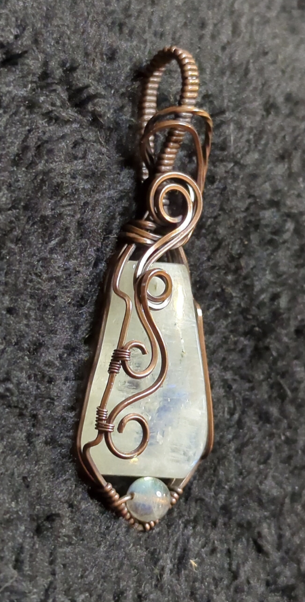 Moonstone pendant with blue flash, accented with Labradorite, set in antiqued copper.