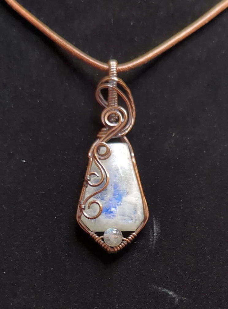 Moonstone pendant with blue flash, accented with Labradorite, set in antiqued copper.